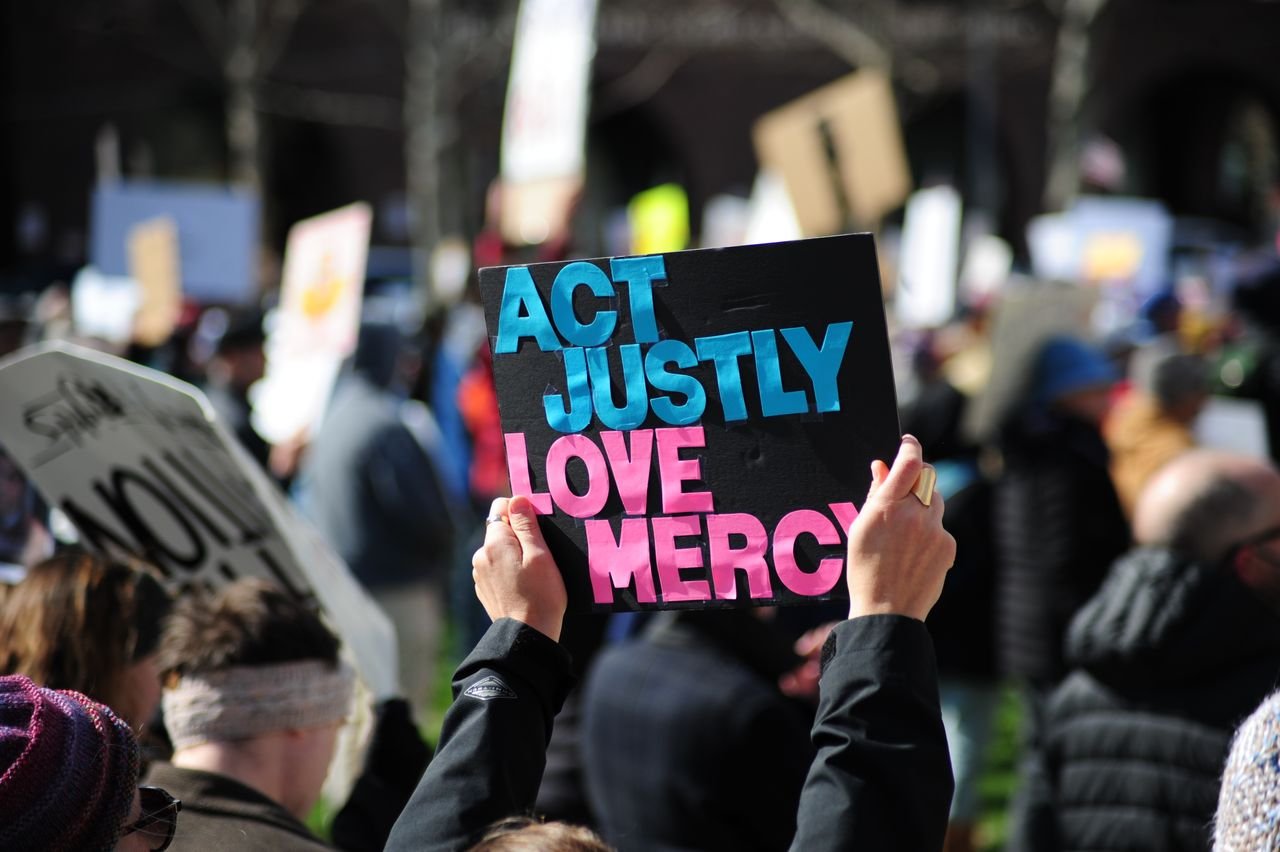 A vibrant street protest in Baltimore, Maryland promoting justice and mercy.